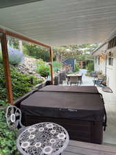 View of patio / terrace featuring a hot tub and outdoor dining area