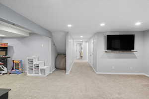 Recreation room featuring light carpet and recessed lighting