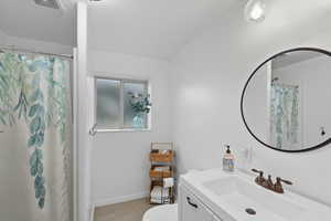 Full bathroom featuring vanity and a shower with shower curtain