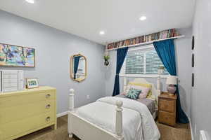 Bedroom with dark carpet and recessed lighting