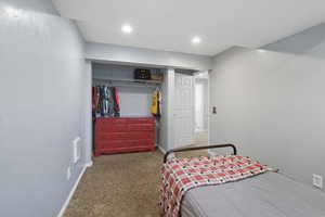 Carpeted bedroom featuring a closet and recessed lighting