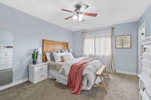 Bedroom with light carpet and ceiling fan