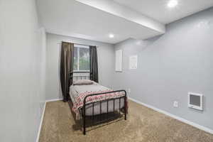 Bedroom with carpet floors and heating unit