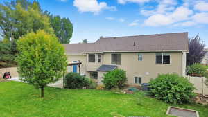 Back of house with a shingled roof