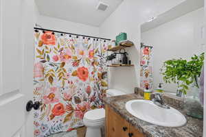 Bathroom featuring vanity and a shower with shower curtain