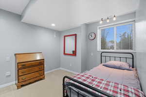 Bedroom with light tile patterned flooring and recessed lighting