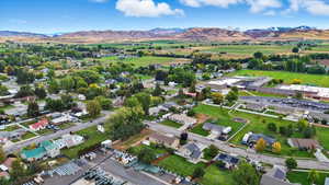 Aerial view of property's location with a mountain backdrop and nearby suburban area