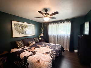 Bedroom featuring wood finished floors, a textured ceiling, and ceiling fan