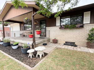 Property entrance with brick siding and covered porch