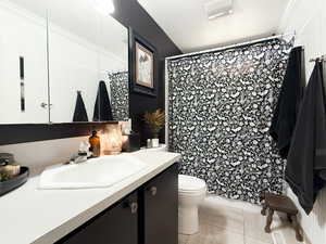 Bathroom with vanity, tile patterned flooring, crown molding, and a shower with curtain