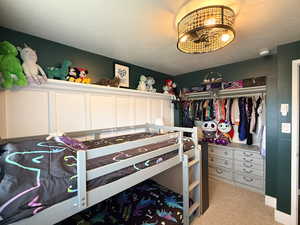 Carpeted bedroom with a textured ceiling