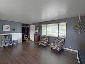 Living area with wood finished floors and a textured ceiling