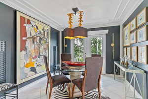 Dining room featuring crown molding and light tile patterned floors