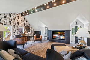 Living area featuring healthy amount of natural light and carpet