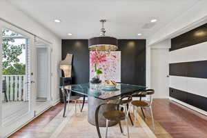 Dining room with recessed lighting, wood finished floors, and a chandelier