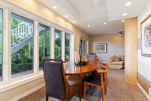 Carpeted dining room featuring recessed lighting and healthy amount of natural light