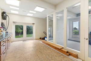 Exercise room featuring french doors