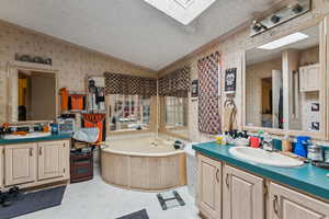 Primary bathroom with vanity, a garden tub, separate shower.