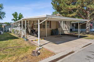 View of front of house with an attached carport.