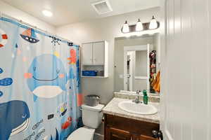Bathroom with vanity and curtained shower