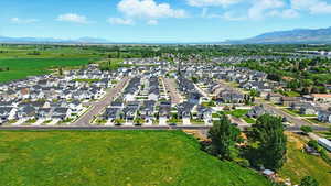 Aerial view of property's location featuring a mountainous background and nearby suburban area