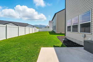 Fenced backyard featuring a patio and a mountain view