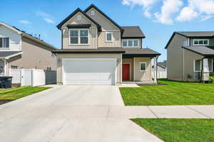 Craftsman inspired home with board and batten siding, a garage, and concrete driveway