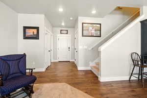 Foyer entrance featuring stairway, wood finished floors, and recessed lighting