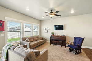Living room with ceiling fan and recessed lighting