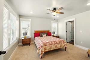 Bedroom with carpet, multiple windows, ceiling fan, and recessed lighting