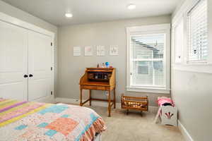 Bedroom featuring carpet floors and a closet