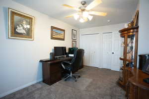 Office space featuring carpet and ceiling fan