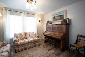 Living area with a chandelier and wood finished floors