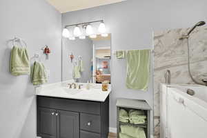 Full bathroom with vanity and a shower