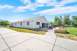 View of front facade featuring a patio and a front yard