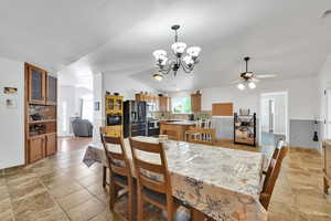 Dining space featuring ceiling fan, a chandelier, and a textured ceiling