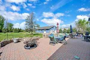 View of patio with an outdoor fire pit and outdoor dining space