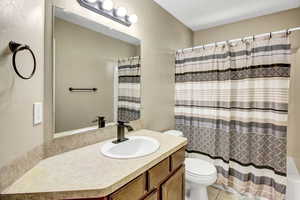 Bathroom featuring vanity, a shower with shower curtain, and tile patterned flooring