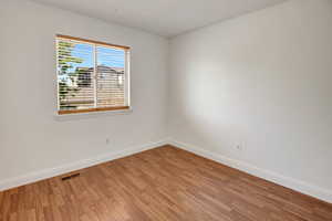 Unfurnished room with light wood-style flooring and baseboards