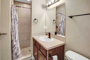 Bathroom with vanity and tiled shower