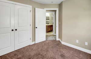 Unfurnished bedroom featuring carpet floors and a closet