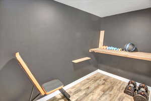 Staircase featuring wood finished floors and baseboards