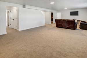 Unfurnished living room featuring carpet and recessed lighting