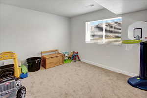 Playroom featuring carpet flooring and baseboards