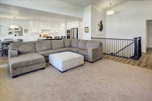 Living area with wood finished floors, recessed lighting, and vaulted ceiling
