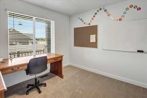 Office area with light carpet and baseboards