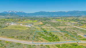 Aerial view of sparsely populated area featuring mountains and property parcel outlined