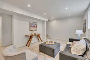 Living room with recessed lighting and light colored carpet