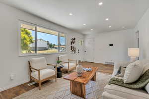 Living area featuring light wood-style floors and recessed lighting