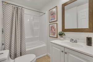 Bathroom featuring vanity, tile patterned floors, and shower / bath combination with curtain